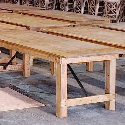 Post Leg Harvest Table with light stain finish, natural wooden legs and slatted tabletop, built with sturdy beams and supports.