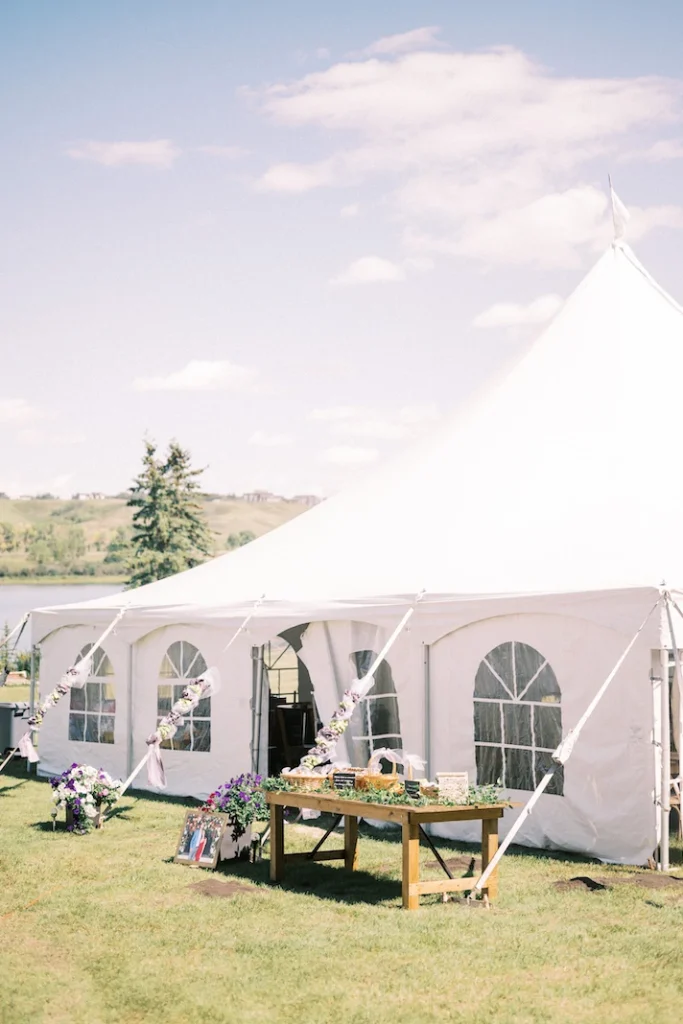 Wedding Tent Packages 11 White event tent with arched window panels and decorated floral details, with Nicole Sarah-themed wedding reception styling outdoors in Calgary.